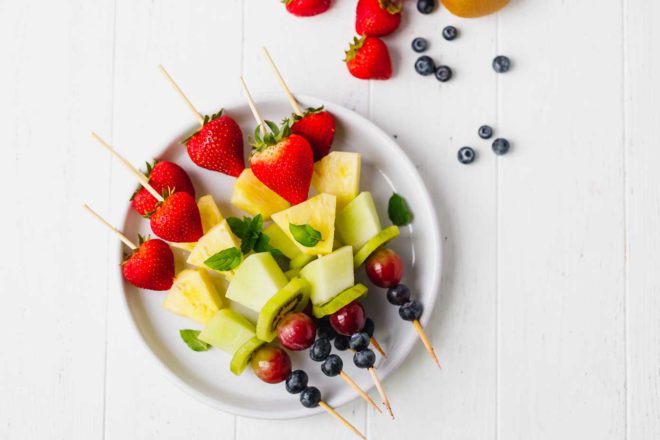 Fruit skewers on a white plate