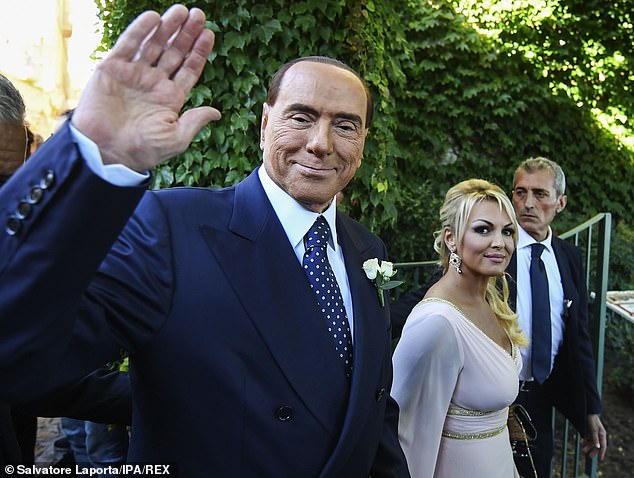 Silvio Berlusconi has been photographed holding hands with his new girlfriend in what is believed to be attempt to 