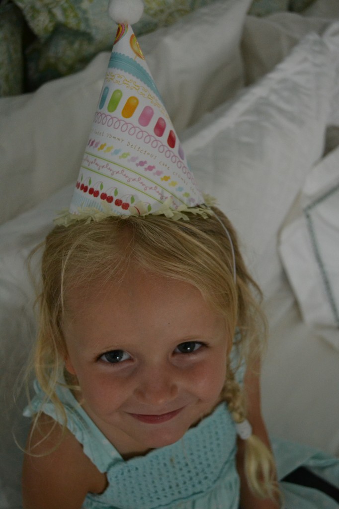 Looking darling in her cute diy paper party hat. 